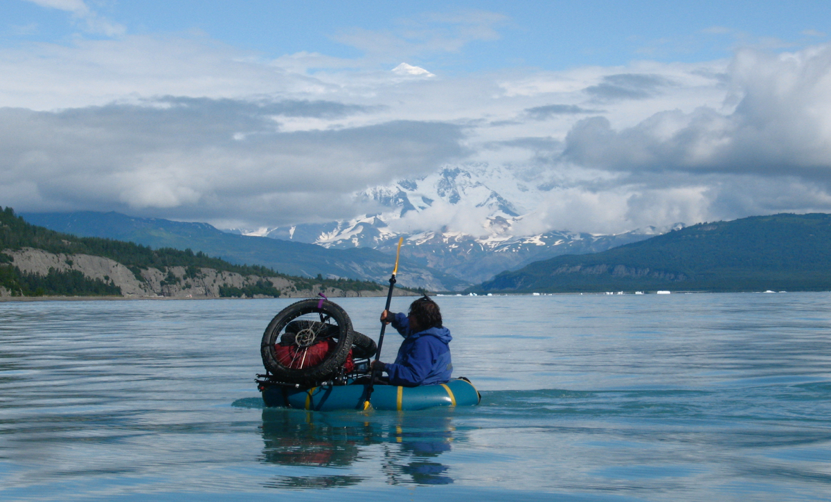 Dylan Kentch paddling across Icy Bay, Alaska, with Mount St. Elias in the background. Photo by Eric Parsons.