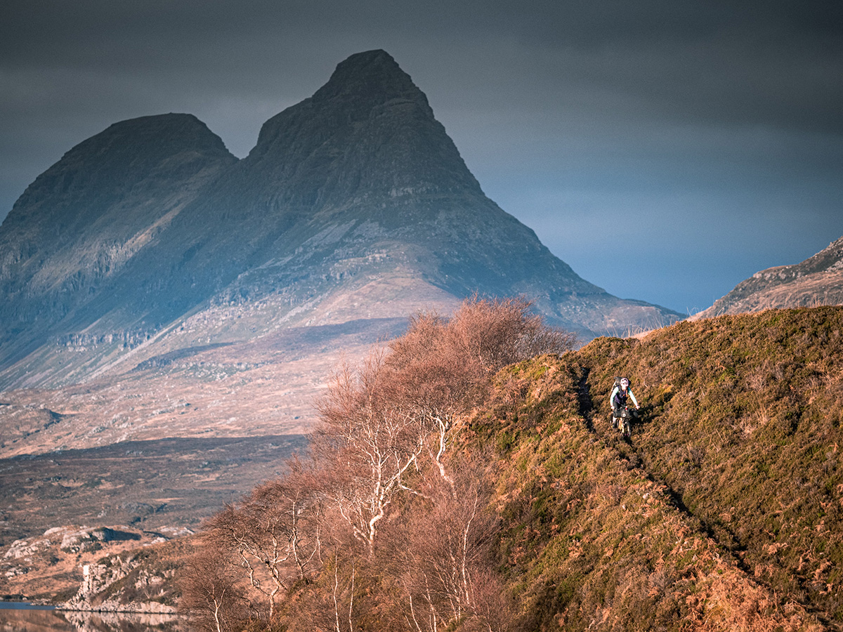 Annie descends steep trail in twilight on Scotland's Highland Trail 550