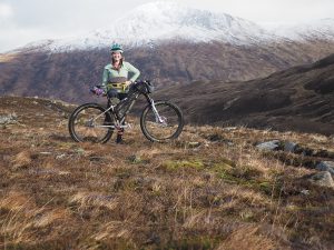 Revelate ambassador Annie Le posing with her bikepacking set up